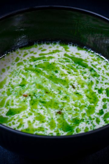Jerusalem artichoke soup with hazelnuts split with parsley oil